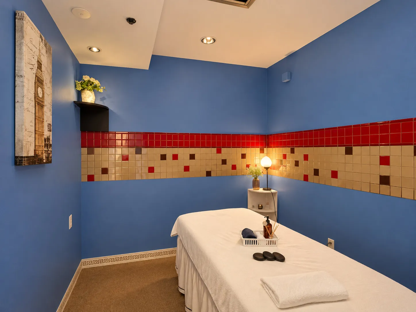 Treatment room at Wellness Massage Spa in Gainesville, FL, a massage table made up with fresh linens under a warm lamp
